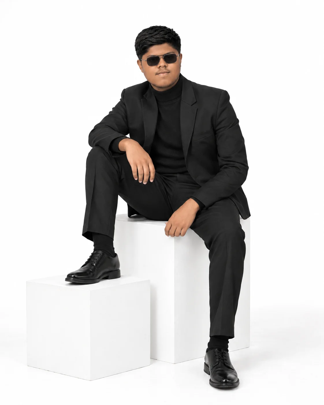 Dhanu, Catalyst head, in a black suit